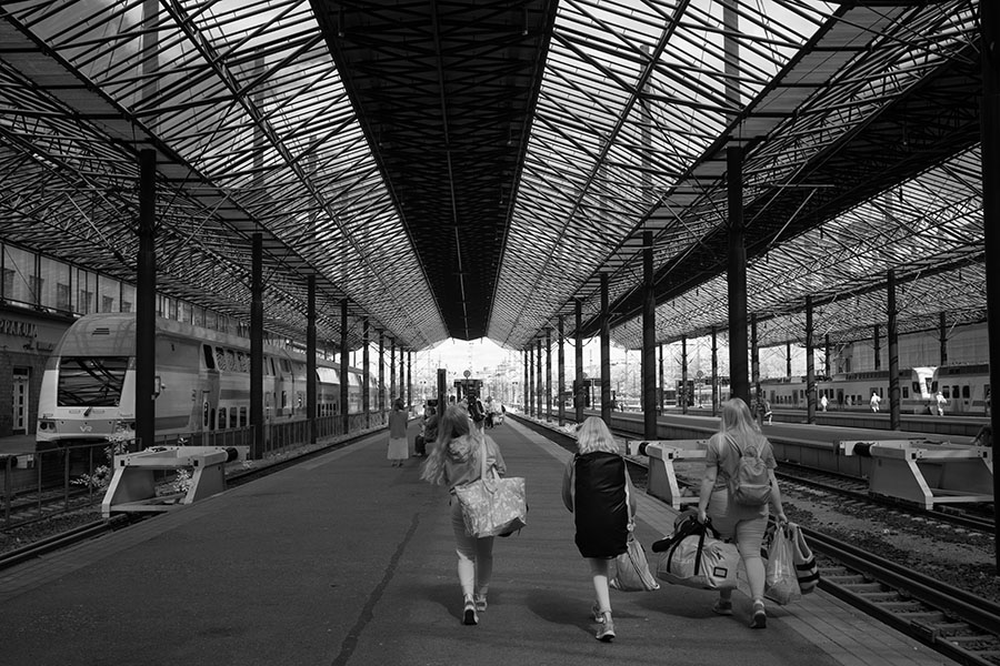 Infrared Photograph of Small Group Walking Down the Platform in Helsinki Train Station.